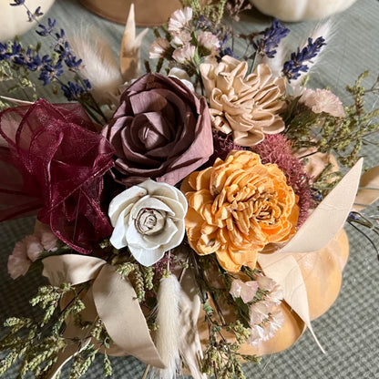 Bouquet of artificial flowers with various colors on a textured surface